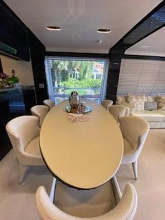 a table with chairs around it aboard FORTUNA Yacht for Sale
