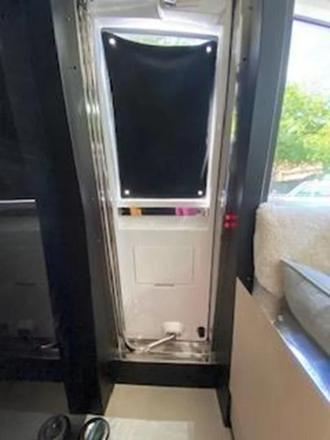 a silver refrigerator in a room aboard FORTUNA Yacht for Sale