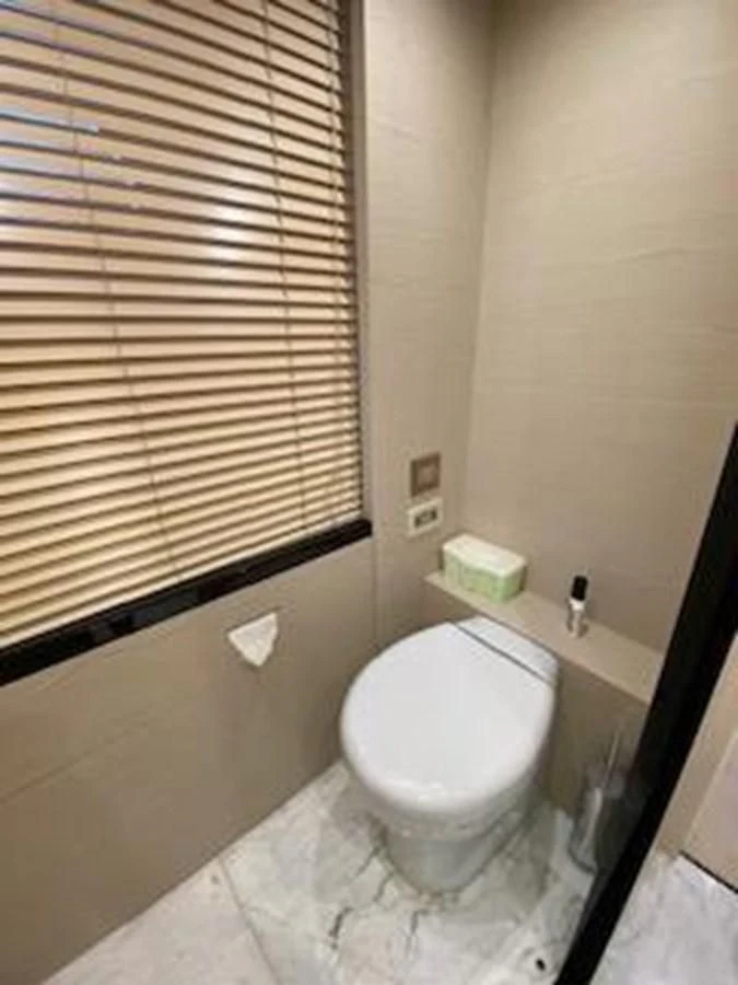 a bathroom with a toilet and a window aboard FORTUNA Yacht for Sale