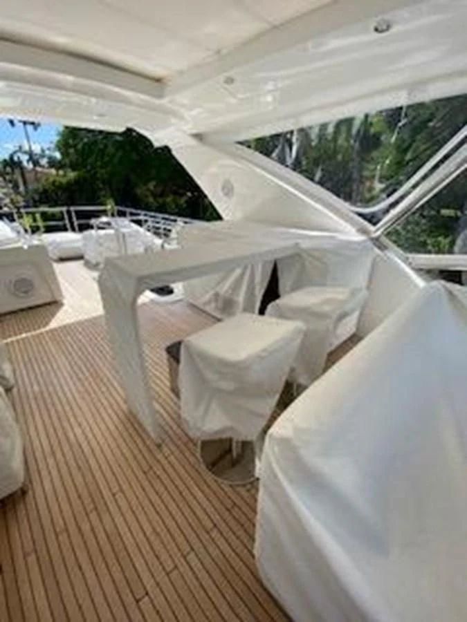 a room with white chairs and a wood floor aboard FORTUNA Yacht for Sale