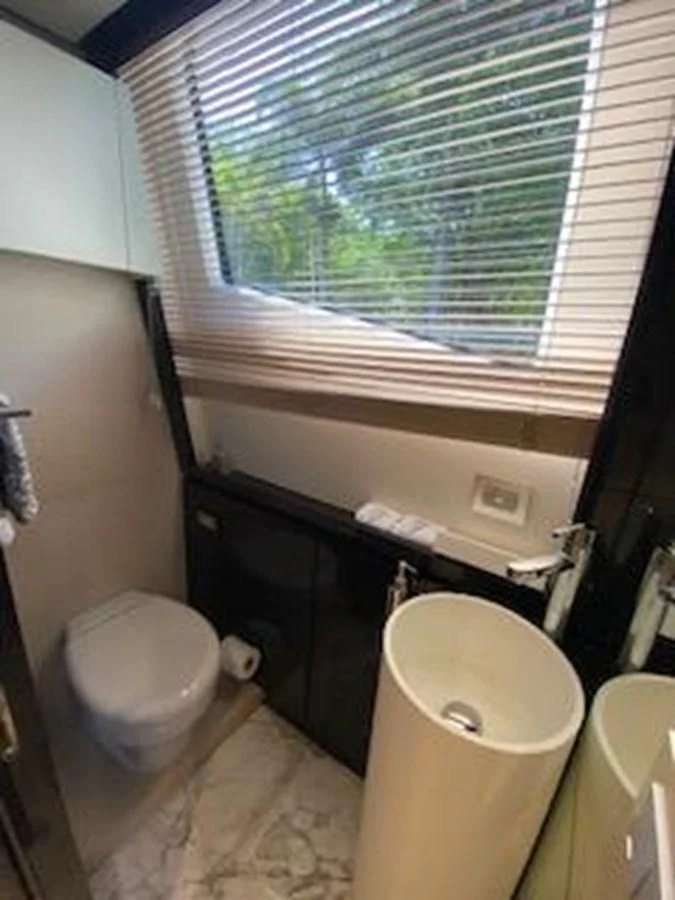 a bathroom with a window aboard FORTUNA Yacht for Sale