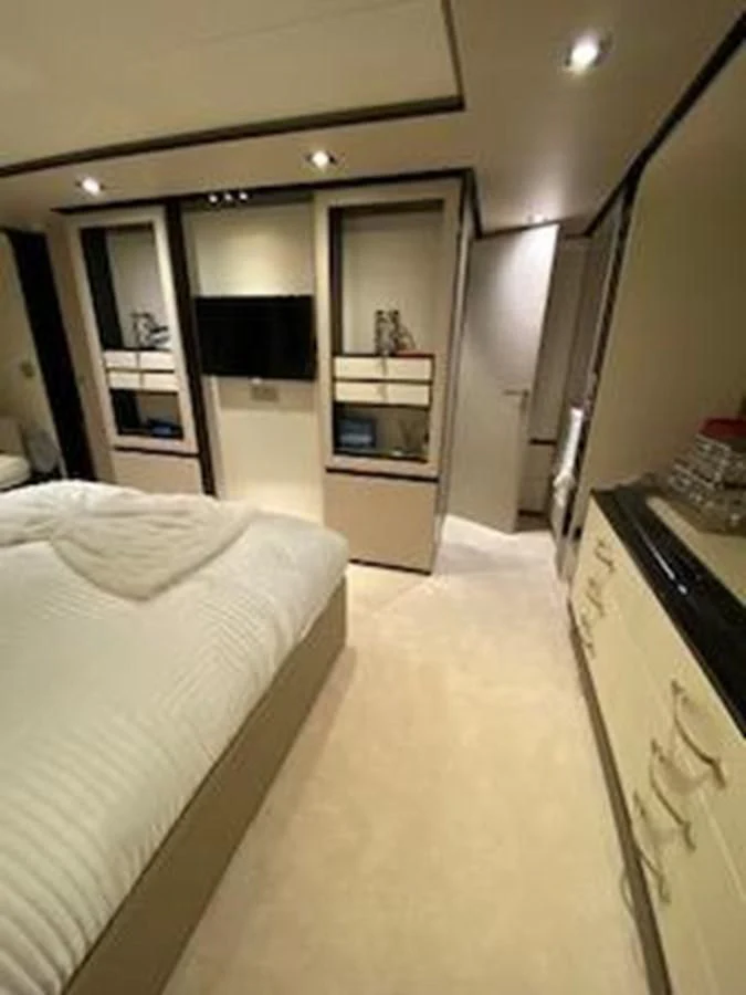 a bedroom with a bed and a microwave aboard FORTUNA Yacht for Sale