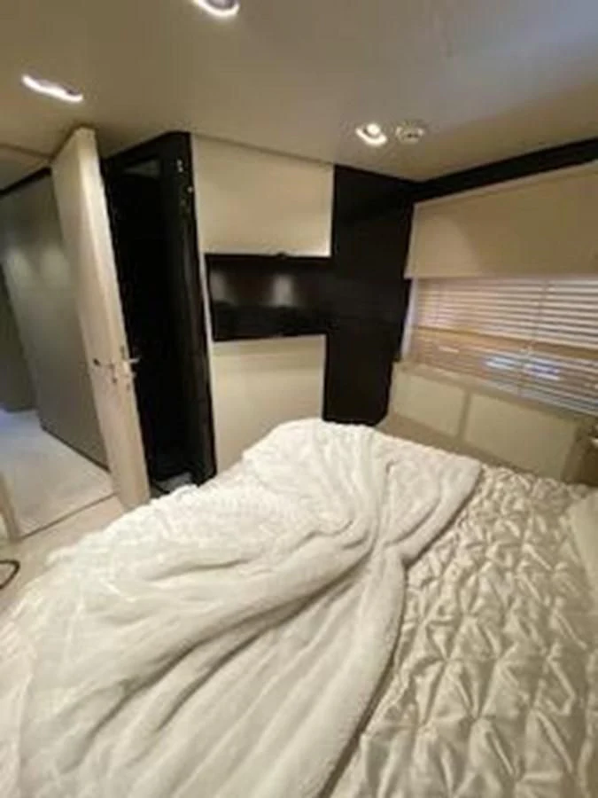 a bed with a white sheet aboard FORTUNA Yacht for Sale