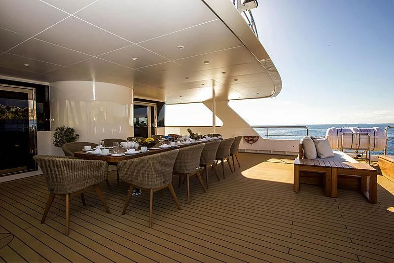 a room with tables and chairs aboard MASQUENADA Yacht for Sale