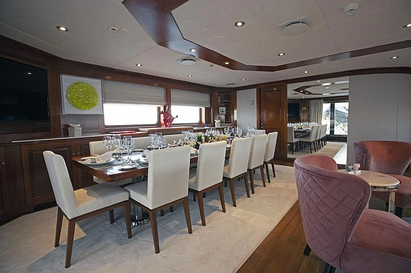 a dining room with a table and chairs aboard MASQUENADA Yacht for Sale
