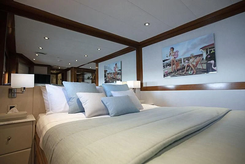 a bed with a white bed spread aboard MASQUENADA Yacht for Sale