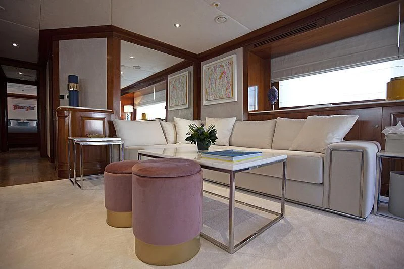a living room with a table and couches aboard MASQUENADA Yacht for Sale