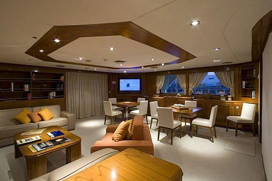 a room with a couch and a table and chairs aboard MASQUENADA Yacht for Sale