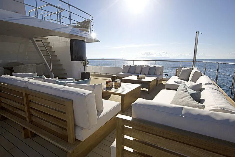 a room with a bed and a table and chairs aboard MASQUENADA Yacht for Sale