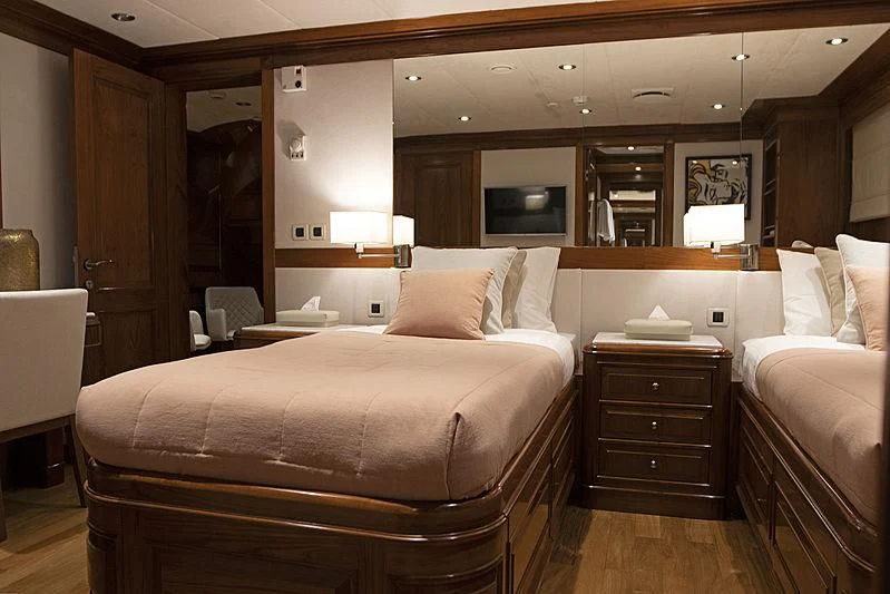 a hotel room with a bed and a mirror aboard MASQUENADA Yacht for Sale