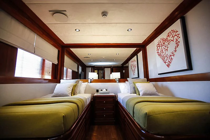 a room with a couple of beds aboard MASQUENADA Yacht for Sale