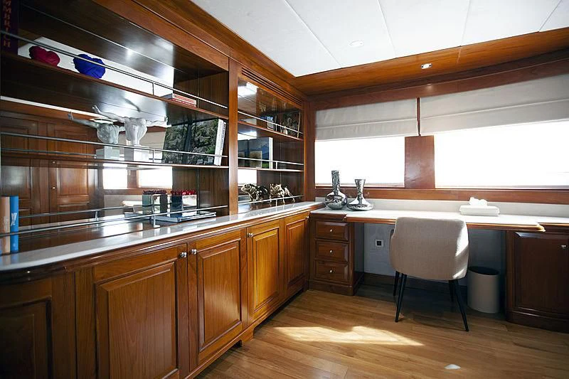 a kitchen with wooden cabinets aboard MASQUENADA Yacht for Sale