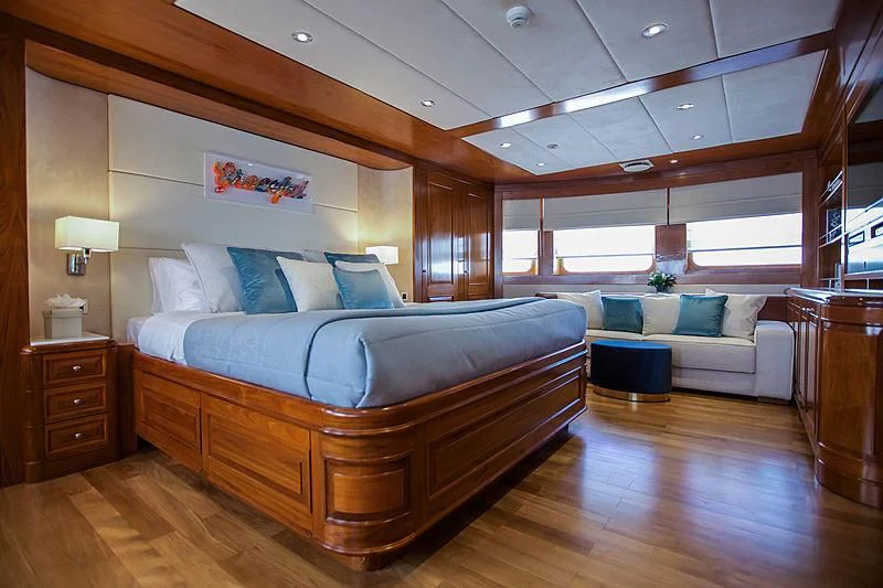 a large bedroom with a large bed aboard MASQUENADA Yacht for Sale