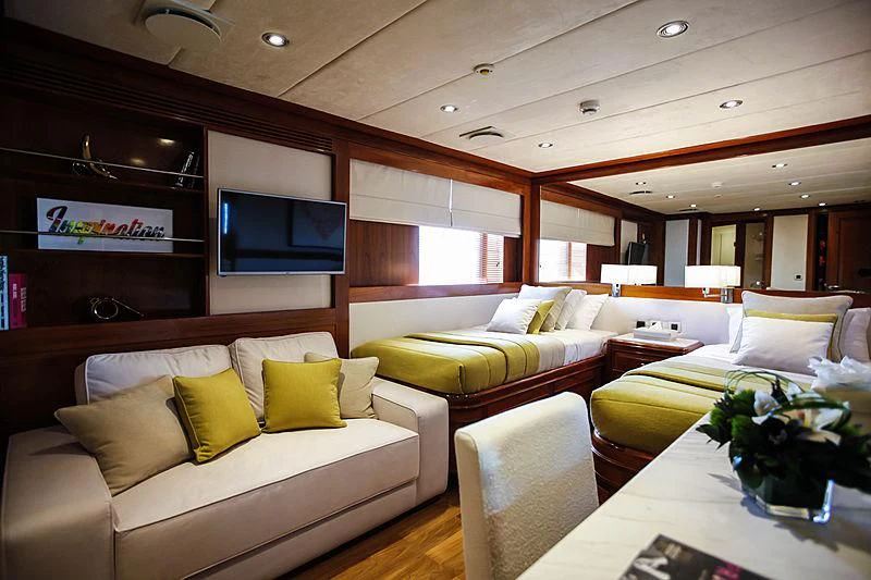 a room with couches and a tv aboard MASQUENADA Yacht for Sale