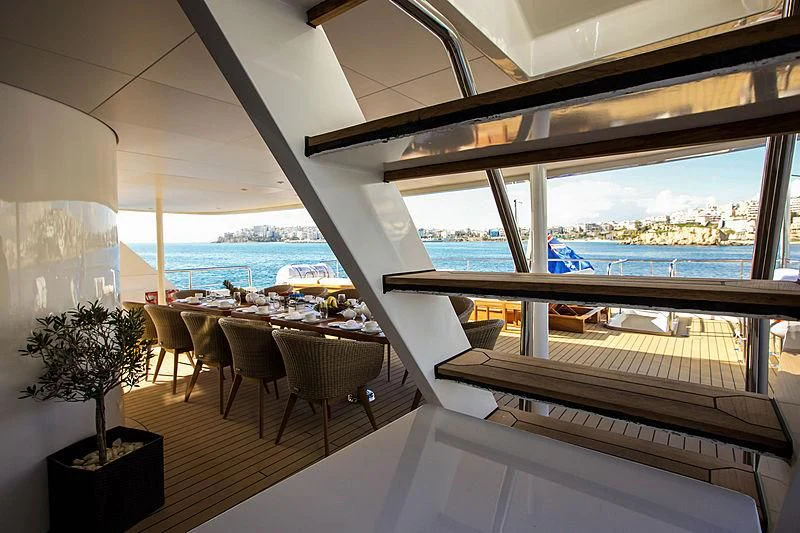 a room with tables and chairs aboard MASQUENADA Yacht for Sale