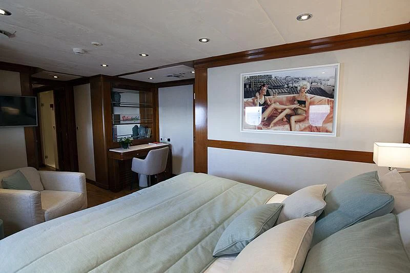 a bedroom with a large screen aboard MASQUENADA Yacht for Sale
