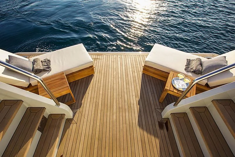a deck with a view of the water and a dock aboard MASQUENADA Yacht for Sale