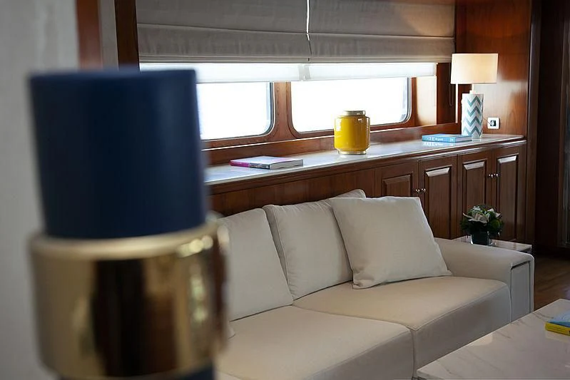 a living room with a white couch and a coffee table aboard MASQUENADA Yacht for Sale