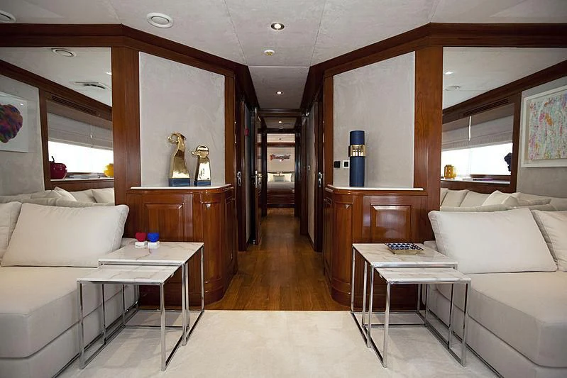 a room with a table and couch aboard MASQUENADA Yacht for Sale