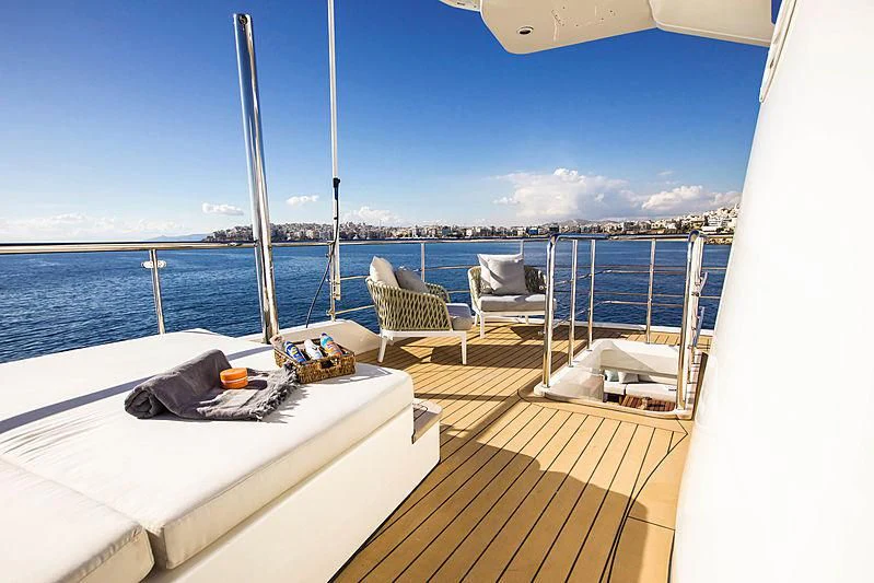 a deck with chairs and a body of water aboard MASQUENADA Yacht for Sale