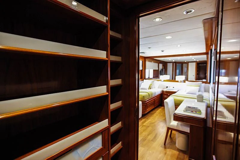 a room with a bed and desk aboard MASQUENADA Yacht for Sale