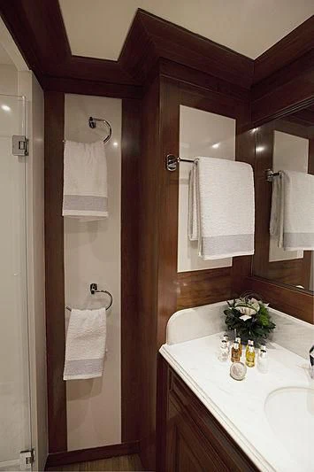 a bathroom with a sink and a mirror aboard MASQUENADA Yacht for Sale