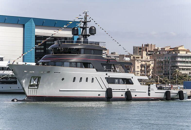 a large white boat in a harbor aboard MASQUENADA Yacht for Sale