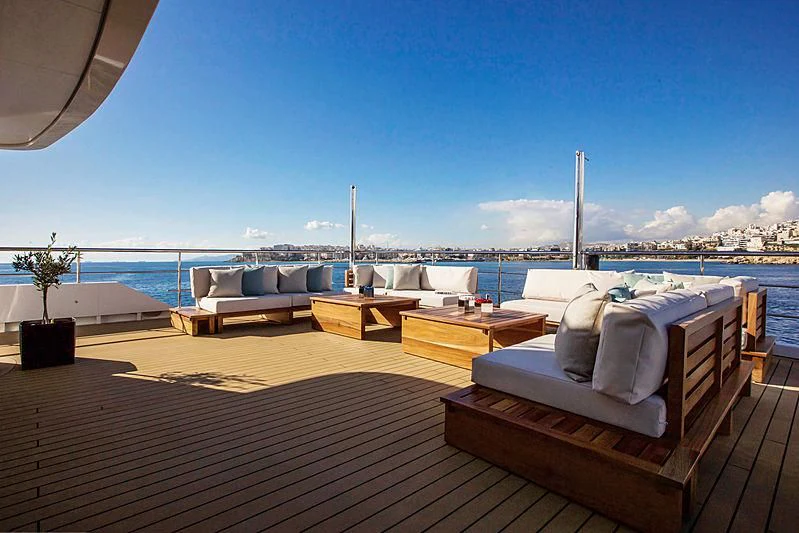 a deck with a view of a city and a body of water aboard MASQUENADA Yacht for Sale