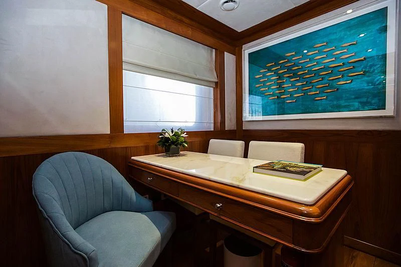 a room with a desk and a chair aboard MASQUENADA Yacht for Sale