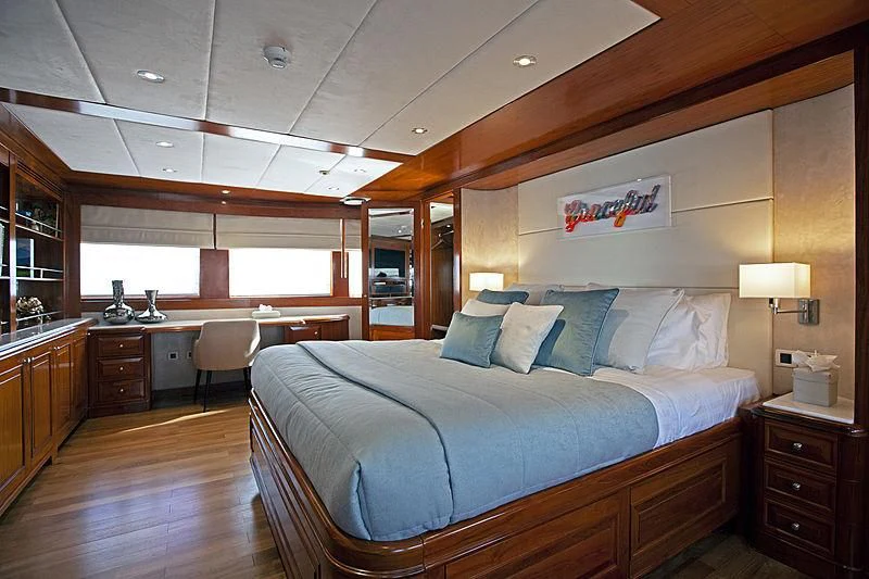 a large bedroom with a large bed aboard MASQUENADA Yacht for Sale