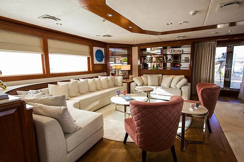 a living room with a couch and a table aboard MASQUENADA Yacht for Sale