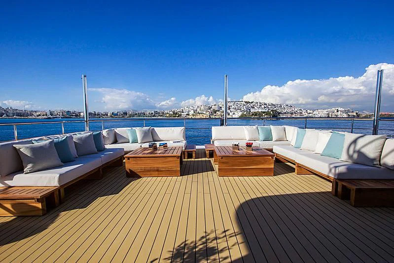 a deck with couches and a view of a city aboard MASQUENADA Yacht for Sale
