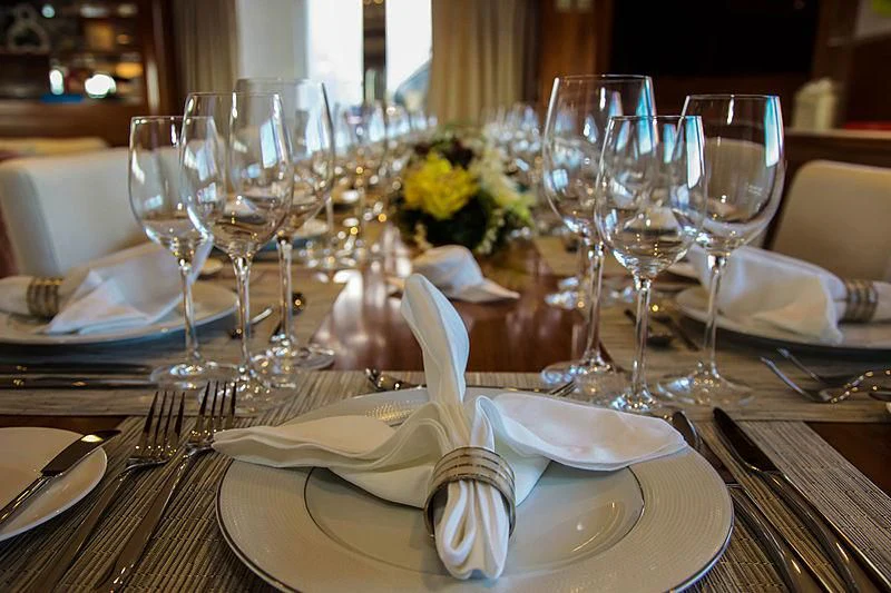 a table with plates and glasses aboard MASQUENADA Yacht for Sale