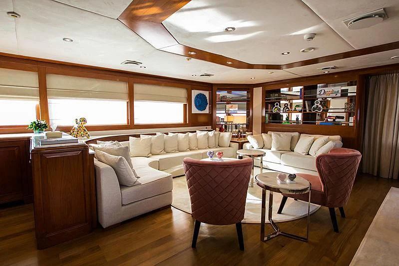 a living room with a couch and a table aboard MASQUENADA Yacht for Sale