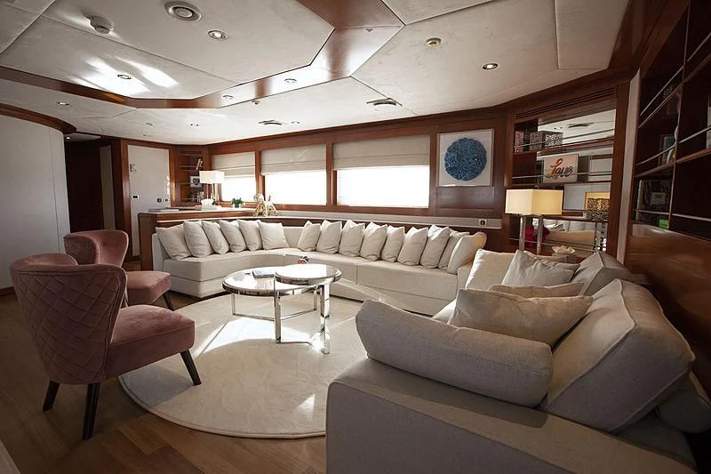 a living room with a couch and a table aboard MASQUENADA Yacht for Sale