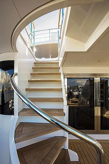 a staircase with glass walls aboard MASQUENADA Yacht for Sale