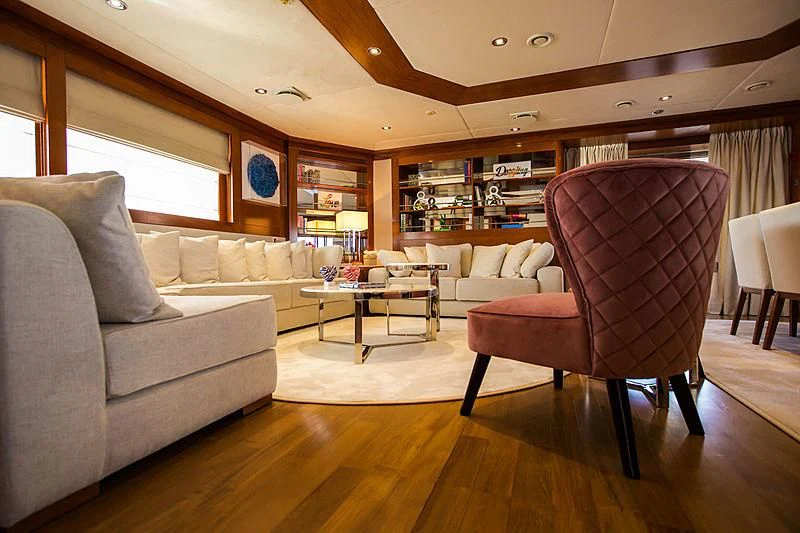 a living room with a couch and a coffee table aboard MASQUENADA Yacht for Sale