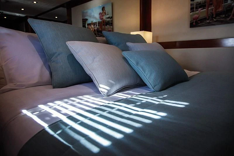 a bed with pillows aboard MASQUENADA Yacht for Sale