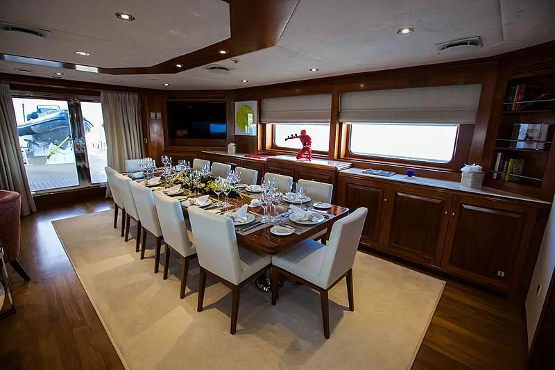 a large kitchen with a dining table aboard MASQUENADA Yacht for Sale