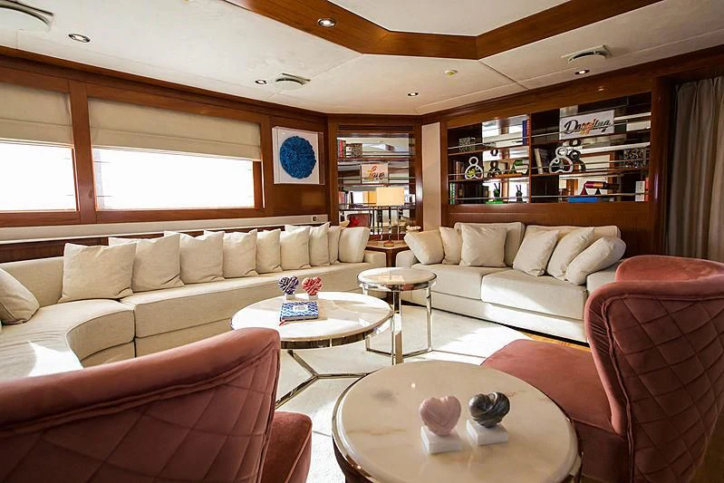 a living room with a couch and a coffee table aboard MASQUENADA Yacht for Sale