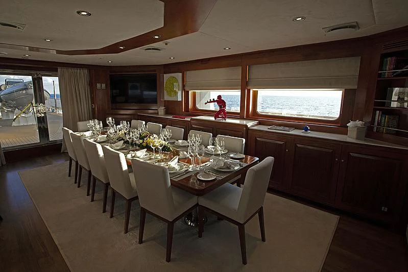 a dining room with a table and chairs aboard MASQUENADA Yacht for Sale