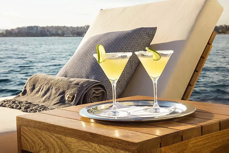 two glasses of drinks on a table aboard MASQUENADA Yacht for Sale