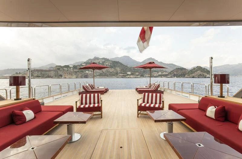 a deck with chairs and tables on it aboard MASQUENADA Yacht for Sale