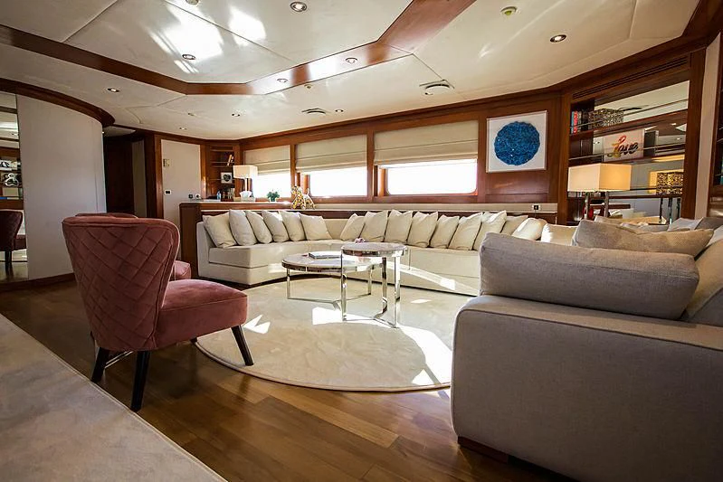 a living room with a couch and a table aboard MASQUENADA Yacht for Sale