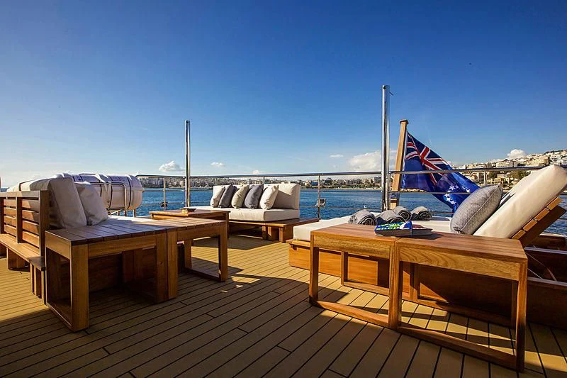 a deck with chairs and tables on it aboard MASQUENADA Yacht for Sale