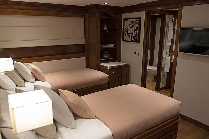 a room with a bed and a television aboard MASQUENADA Yacht for Sale
