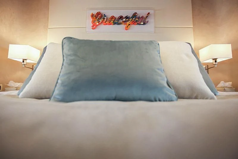 a couch with a pillow and a lamp on it aboard MASQUENADA Yacht for Sale