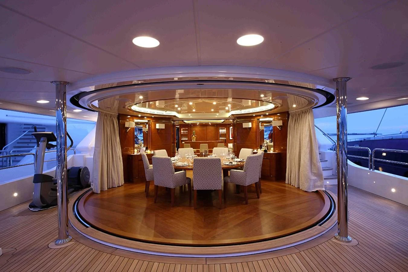 a large room with a table and chairs aboard EVERBLUE Yacht for Sale