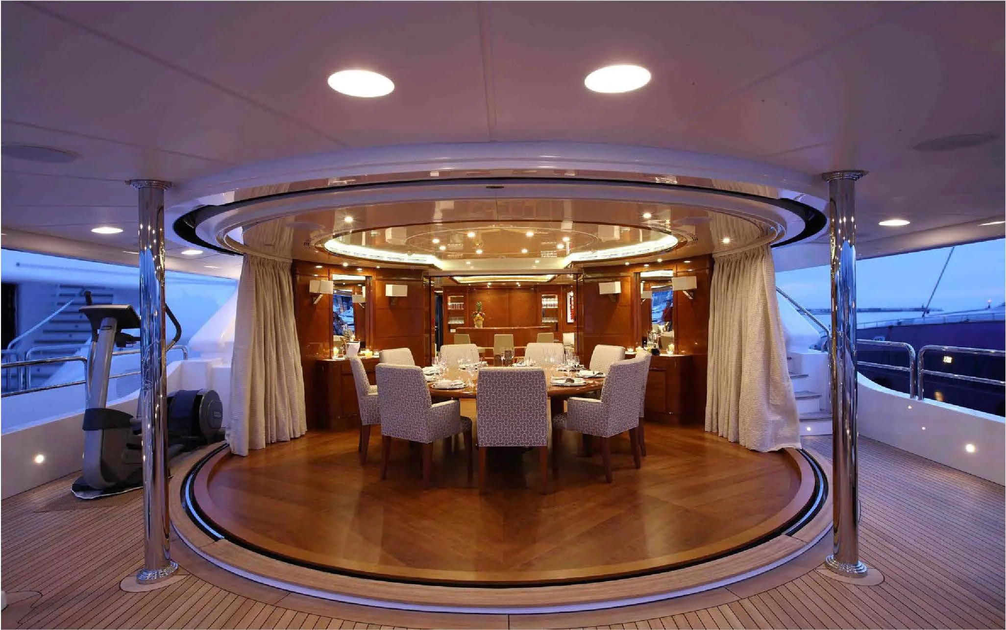 a large room with a table and chairs aboard EVERBLUE Yacht for Sale