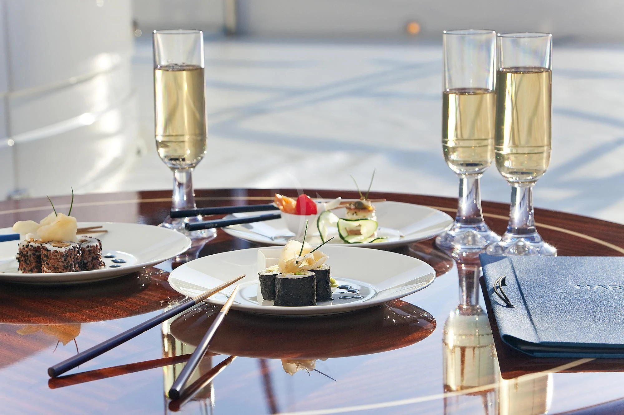 a table with food and wine glasses aboard EVERBLUE Yacht for Sale